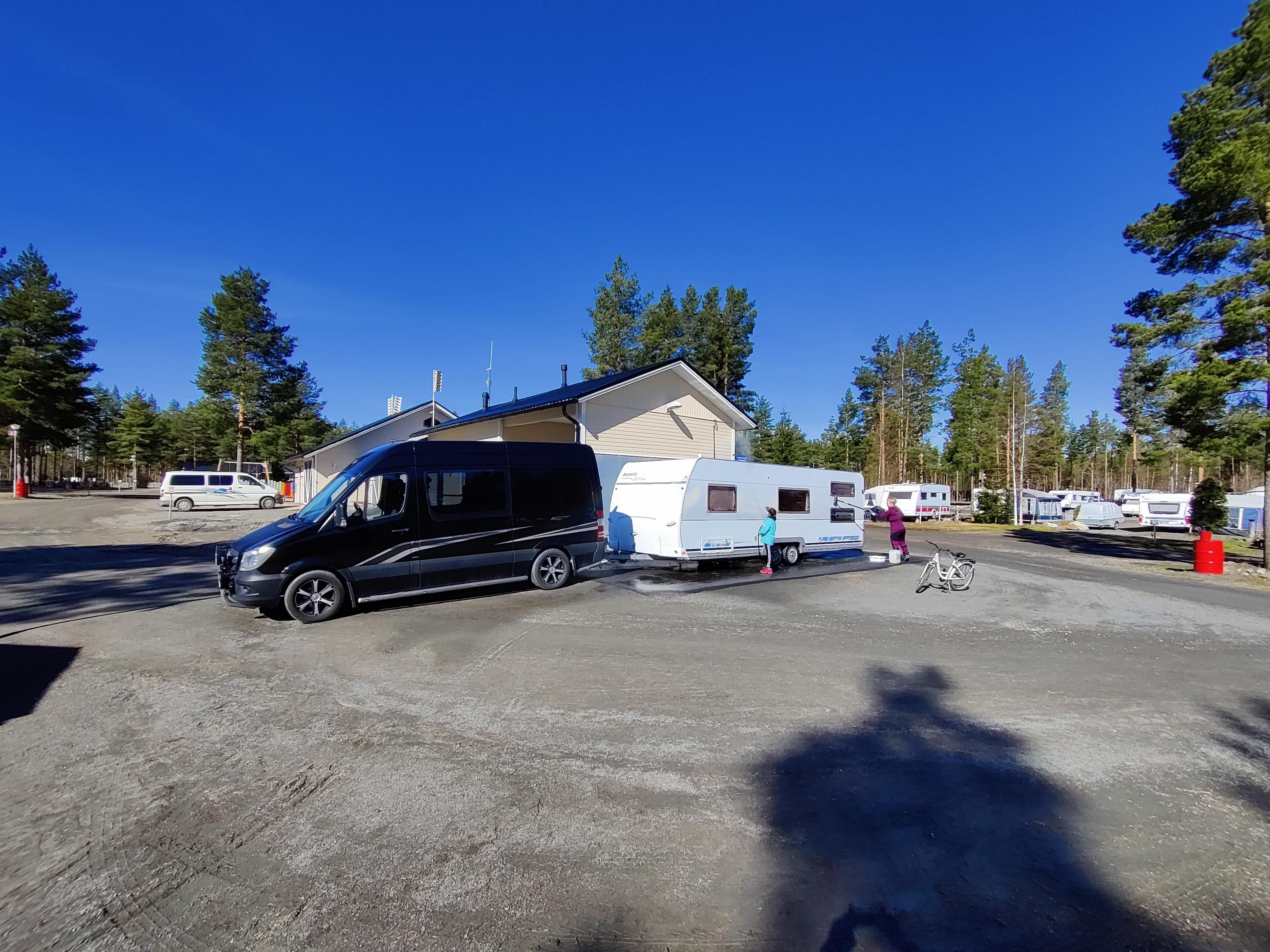 A van towing a caravan inside SF-Caravan-Kalajärvi
