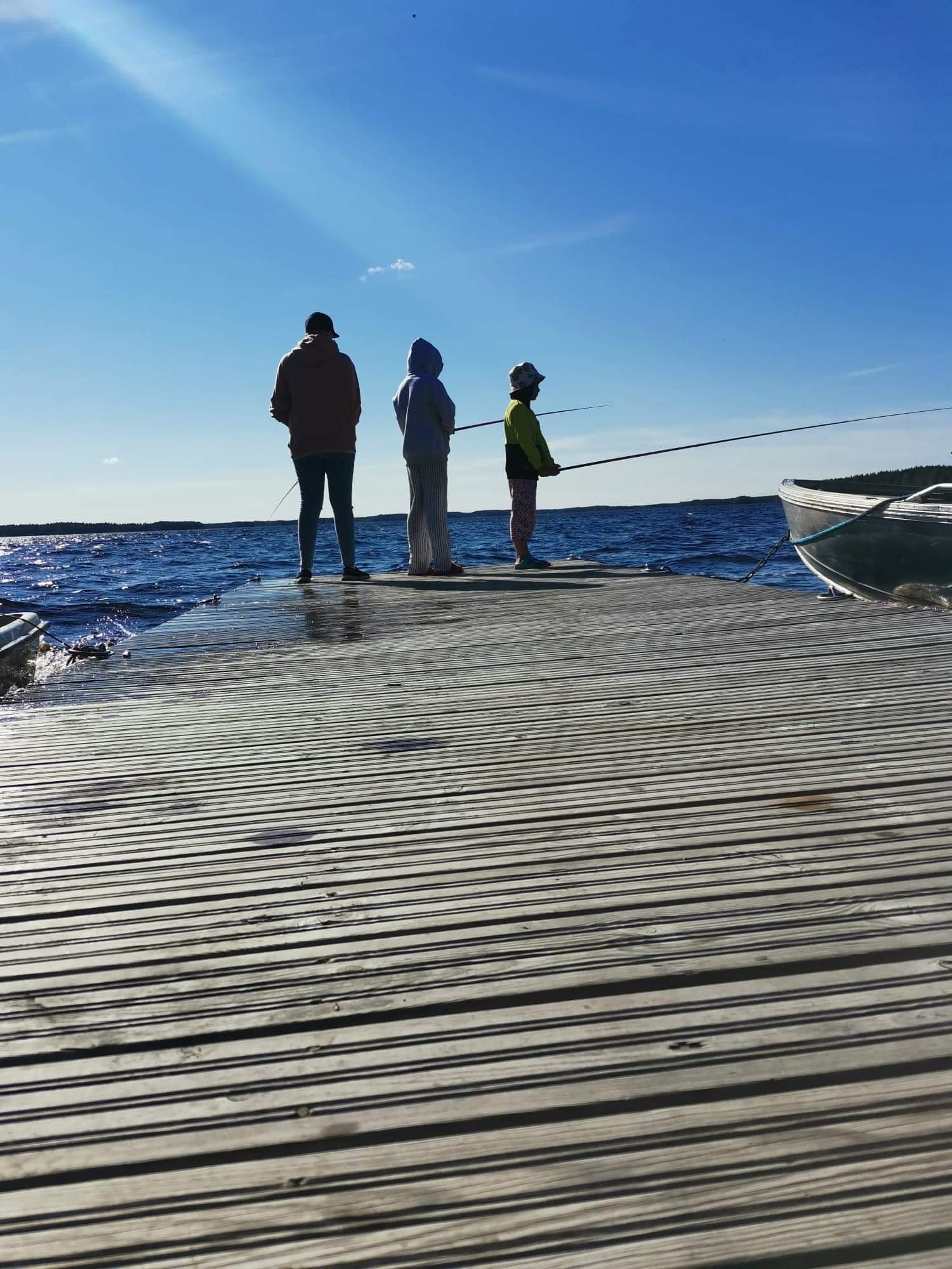 People fishing in Lake Kalajärvi from a wooden jetty
