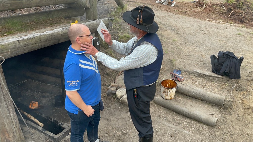 Mark being 'blessed' with a spot of tar on his forehead.